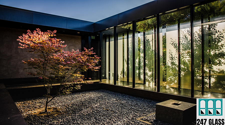 brown and black wooden bench near glass window brown and black wooden bench near glass window