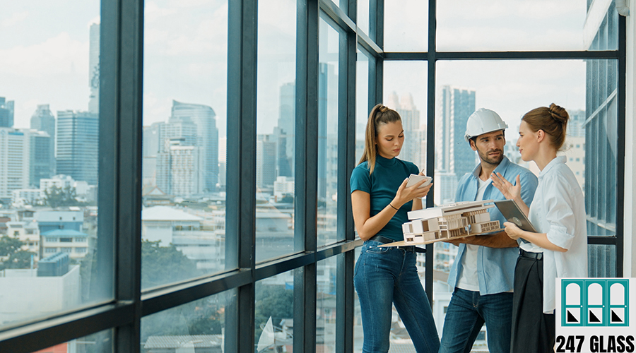 Engineer holds house model and explain about house construction. Tracery Skilled engineer holds house model and explain about house construction to skilled manager. Group of interior designer inspect architectural model. Working together, Civil engineering. Tracery