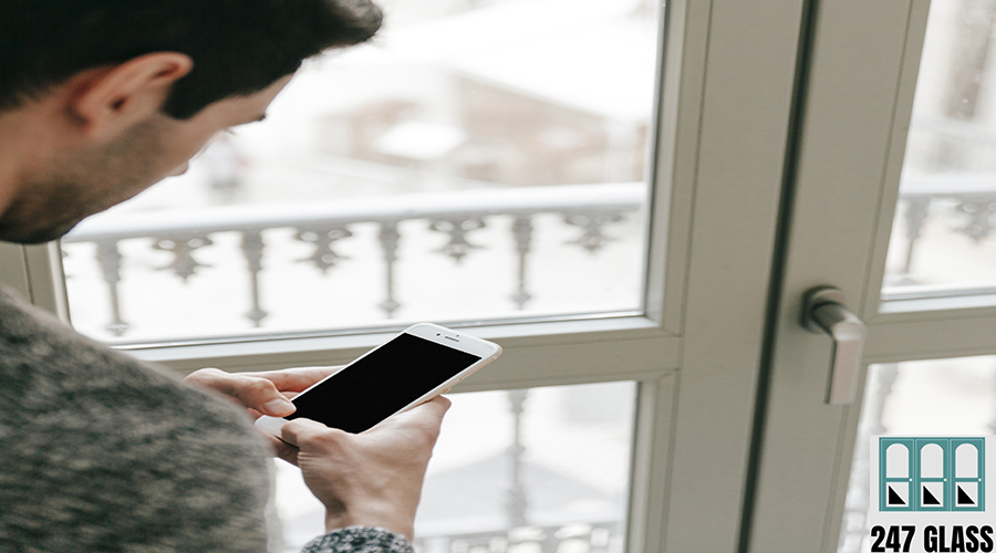 faceless-man-using-smartphone-near-window faceless-man-using-smartphone-near-window