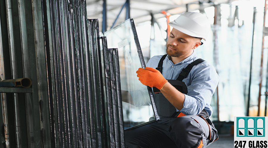 Factory for aluminum and PVC windows and doors production. Manual worker assembling PVC windows and doors Factory for aluminum and PVC windows and doors production. Manual worker assembling PVC windows and doors.