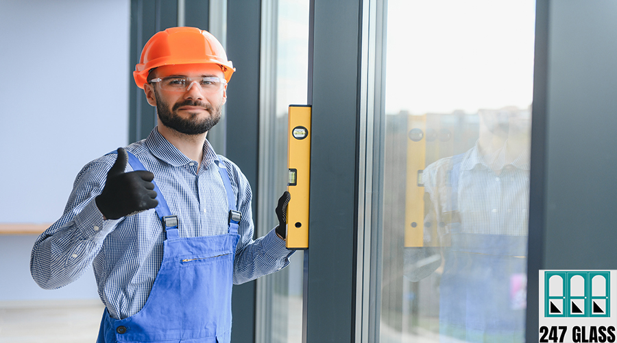 The foreman installs a window frame in the room.