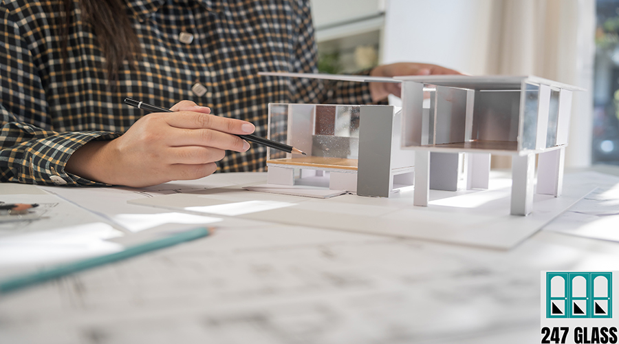 House model on Buleprint construction drawing and drawing equipm House model on Buleprint construction drawing and drawing equipment stationary Architect analyzing house model house modern in hand Architect Design Concept