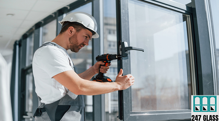 Installing new windows. Close up view of repairman that is working indoors in the modern room Installing new windows. Close up view of repairman that is working indoors in the modern room.