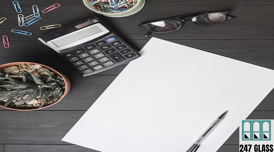 paper-clips-calculator-eyeglasses-potted-plant-with-pen-blank-white-paper