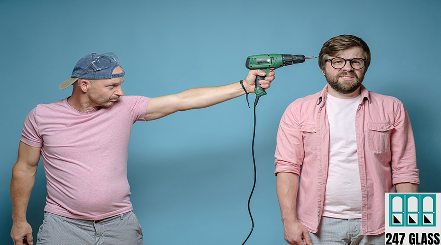 Serious man put an electric screwdriver to the unfortunate male head. Neighbor makes repairs. House noise. Stress concept. Window Installation for Retail Shops
