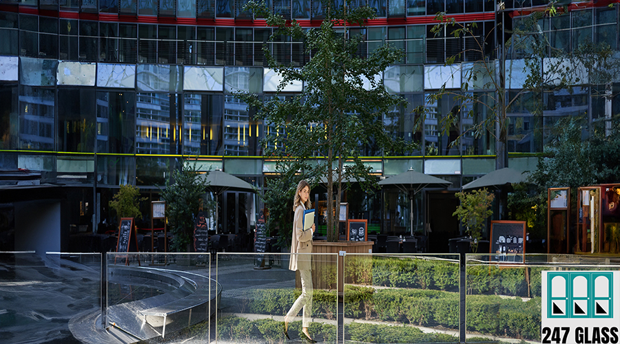Silhouette of young business woman in beige suit, walking in city center, posing near office buildings, going to work Silhouette of young business woman in beige suit, walking in city center, posing near office buildings, going to work.