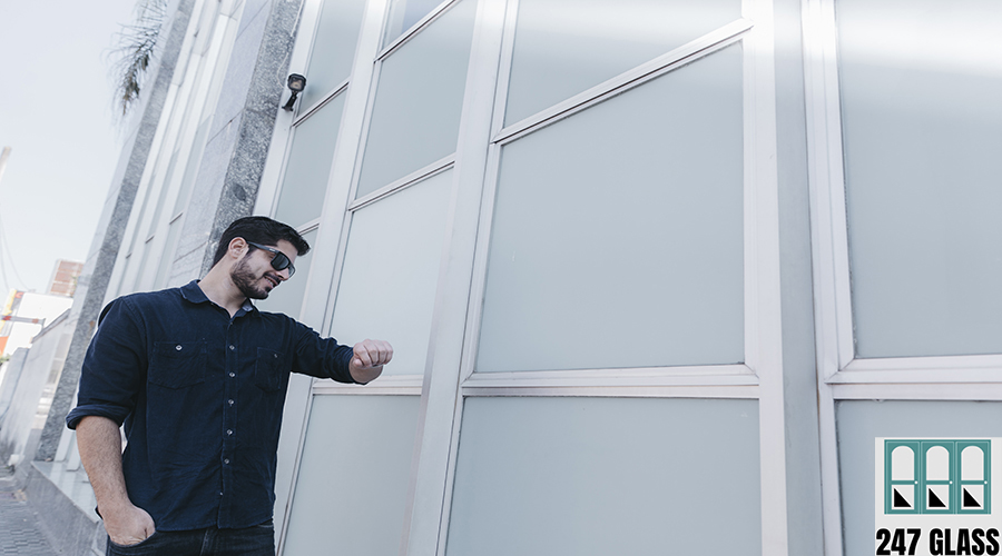 smiling-man-looking-wristwatch-street smiling-man-looking-wristwatch-street