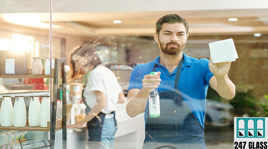 Coffeeshop owner cleaning glass walls Window Installation for Retail Shop