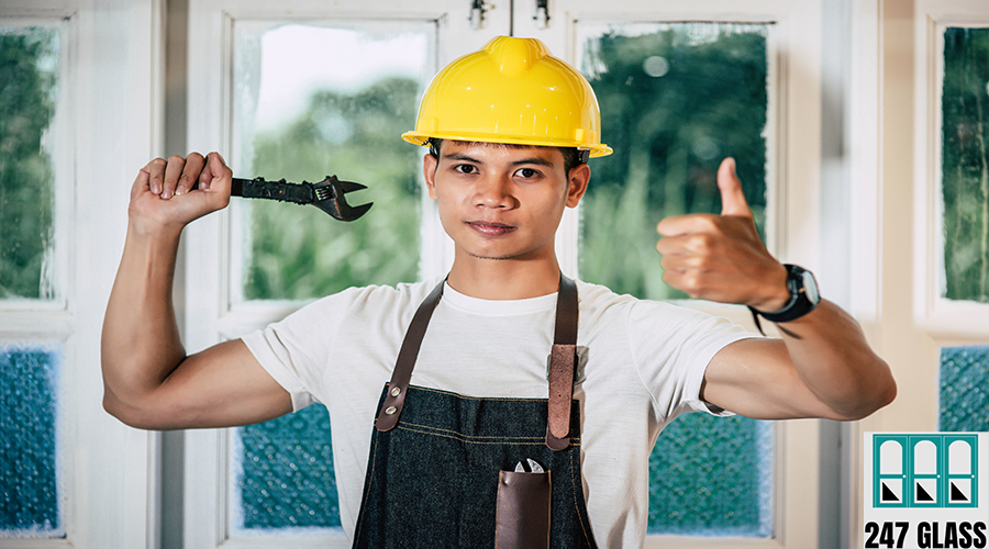 A technician holds a screwdriver and holds a thumb. A technician holds a screwdriver and holds a thumb. Seletive focus.