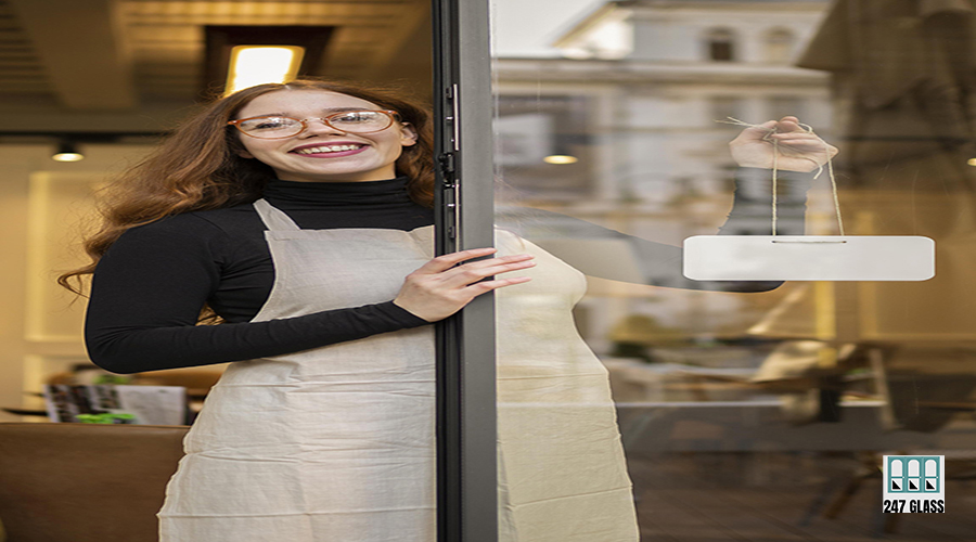 young-woman-holding-shop-sign Storefront Glass Replacement