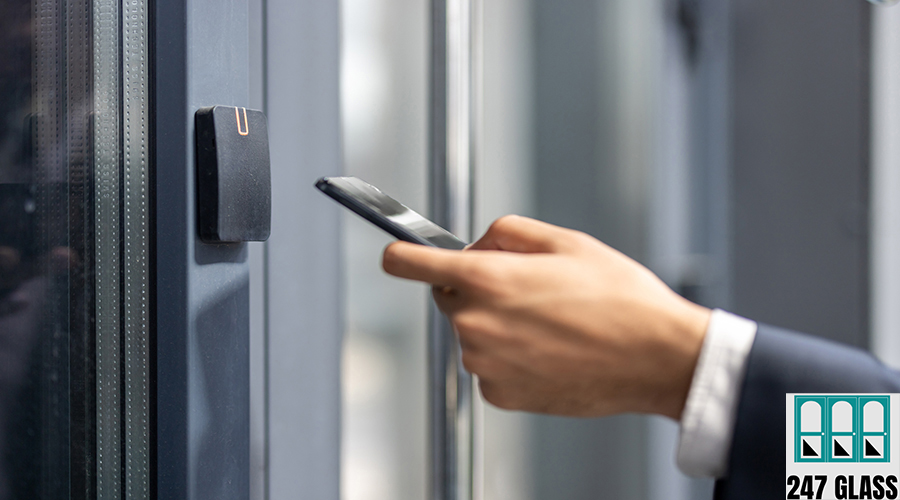 Businessman using smartphone for door access, modern security system. commercial door service