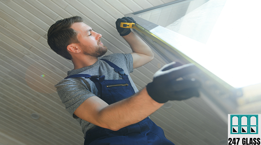 A worker installs windows in a new modular home. The concept of a new home. A worker installs windows in a new modular home. The concept of a new home