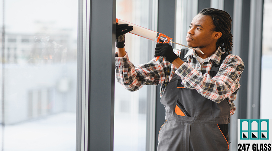 African American Construction worker applying sealant to window frame Professional concentrating on sealing window frame with sealant gun, ensuring airtight and weatherproof installation